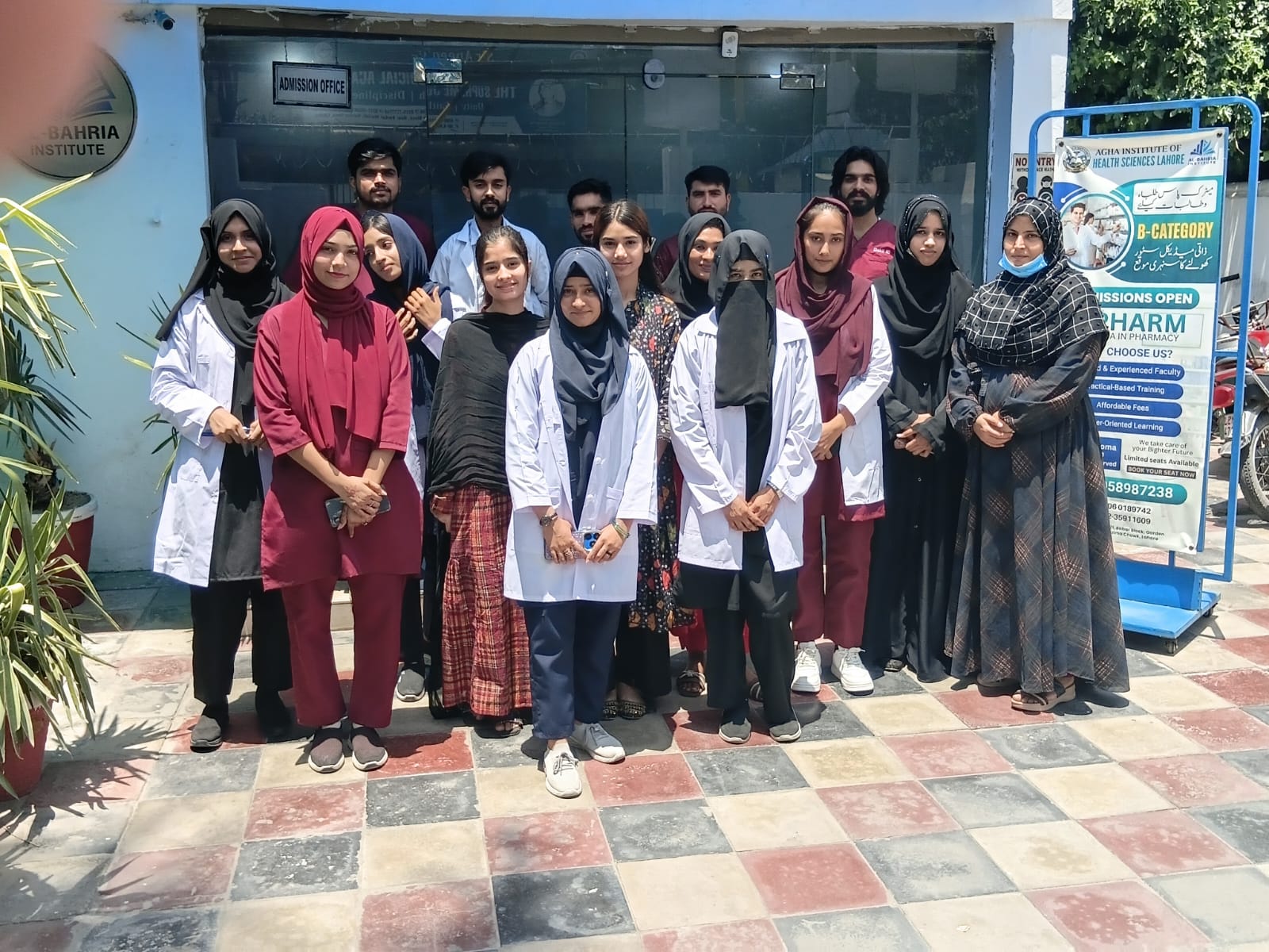Students gathered near the admissions banner at the entrance of the Lahore campus