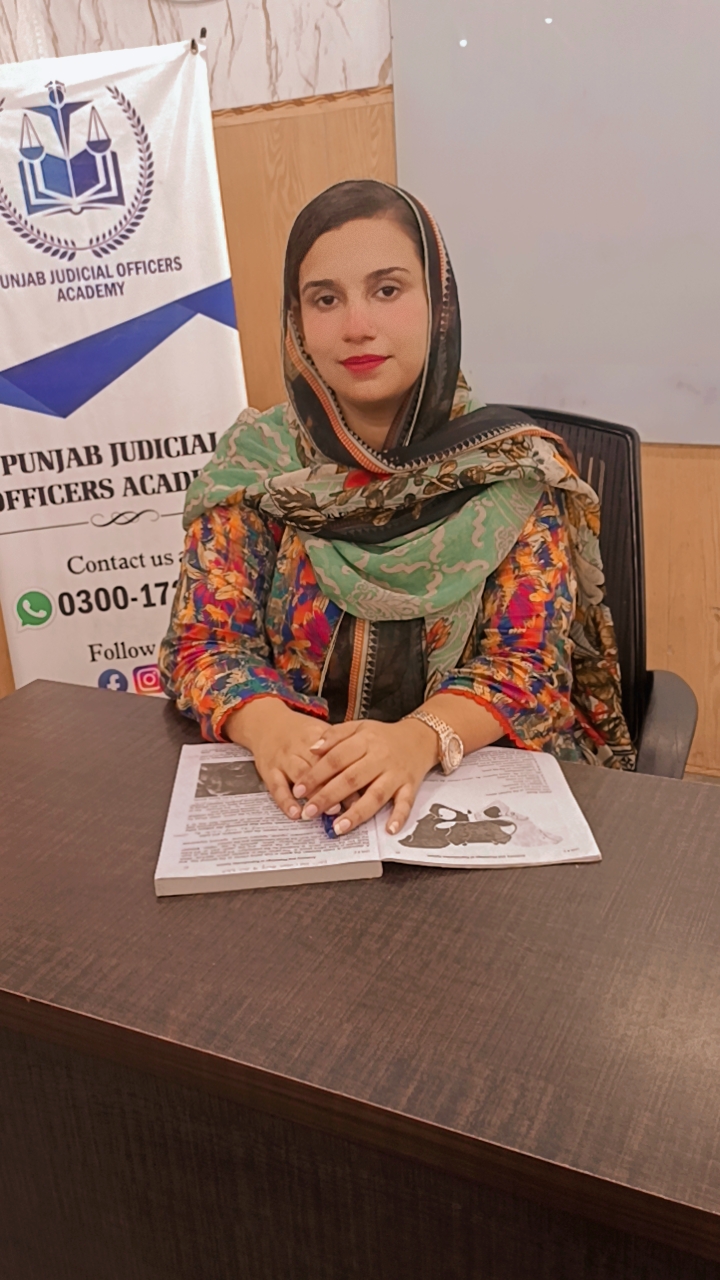 Dr. Zainab Razzaq, Lecturer of Nursing and Midwifery at Agha Institute of Health Sciences Lahore, seated at her desk with study material
